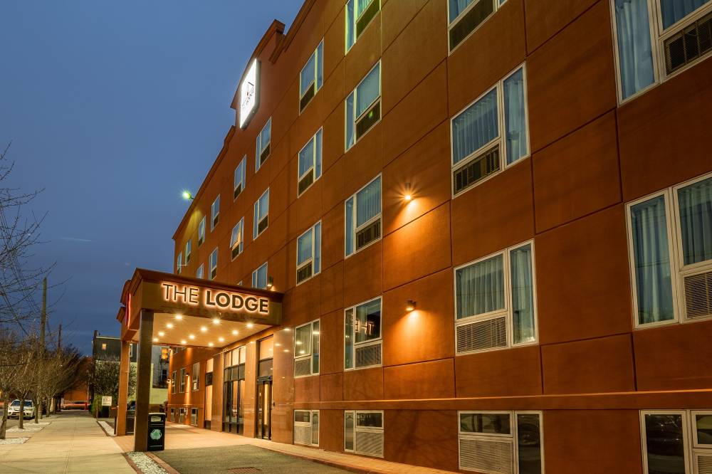 The hotel exterior at night.